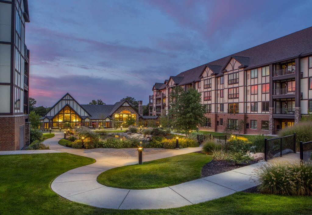 Beacon Hill at Eastgate building exterior in the evening with lighted walking path and landscaped garden areas